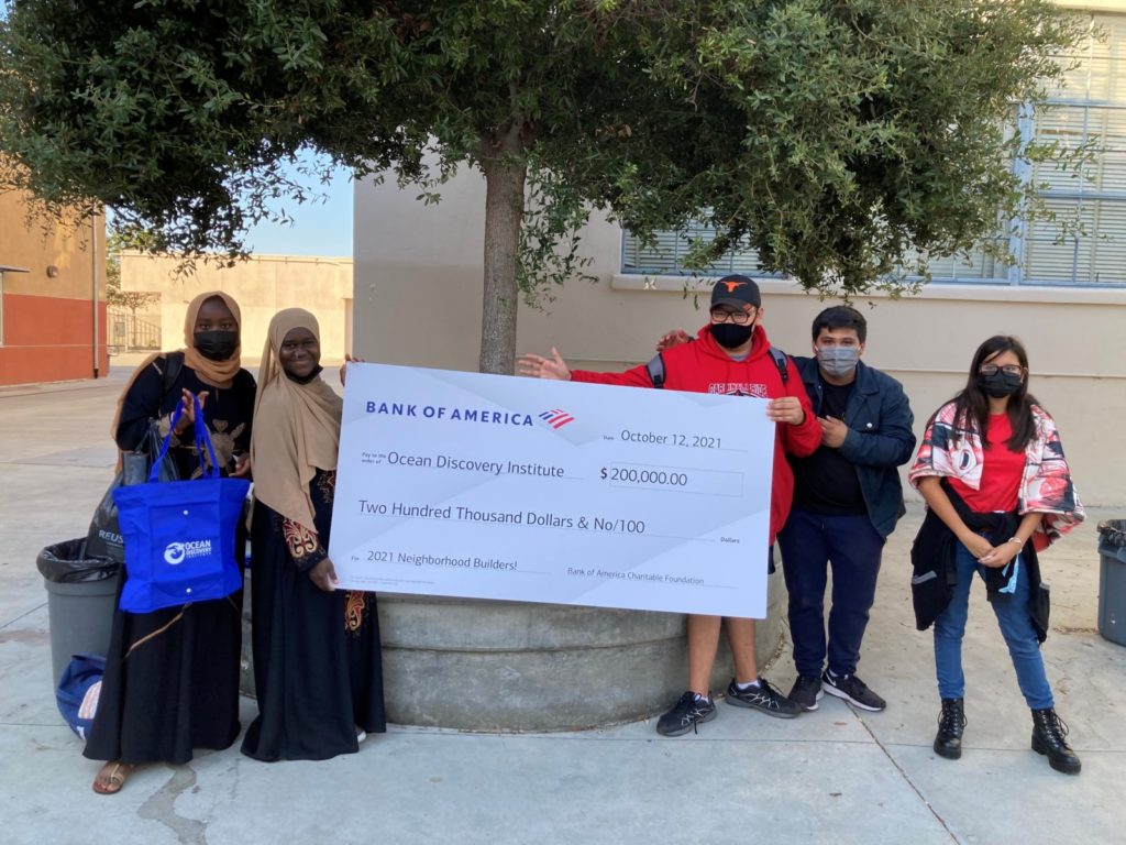 Students pose with a giant check from Bank of America