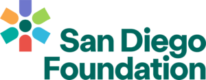 Logo of the San Diego Foundation. The design includes a colorful symbol composed of abstract shapes radiating from a central point, alongside the text "San Diego Foundation" written in a bold, dark green font.