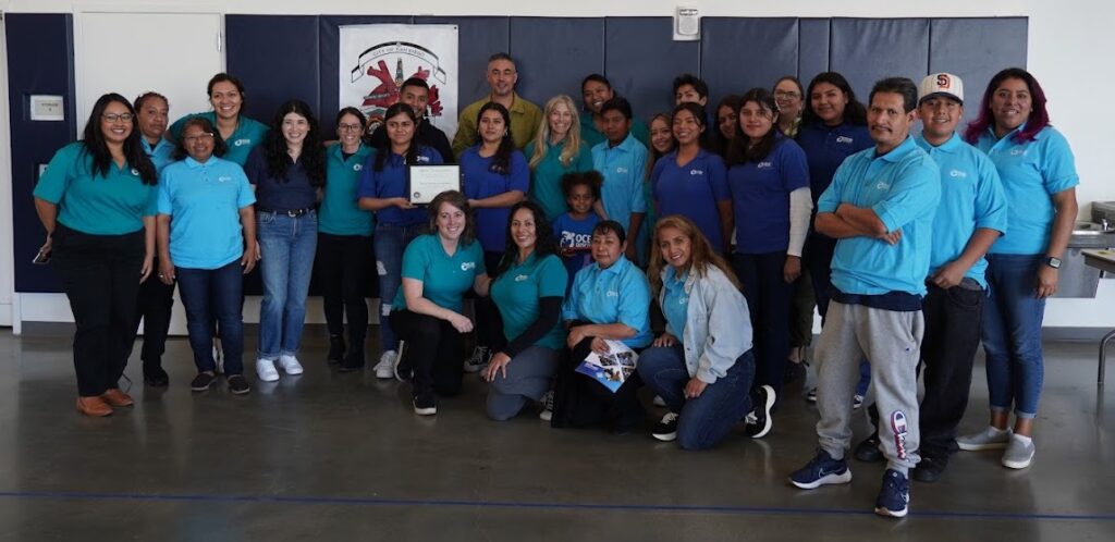 Members of the Ocean Discovery Institute team pose together with an award.